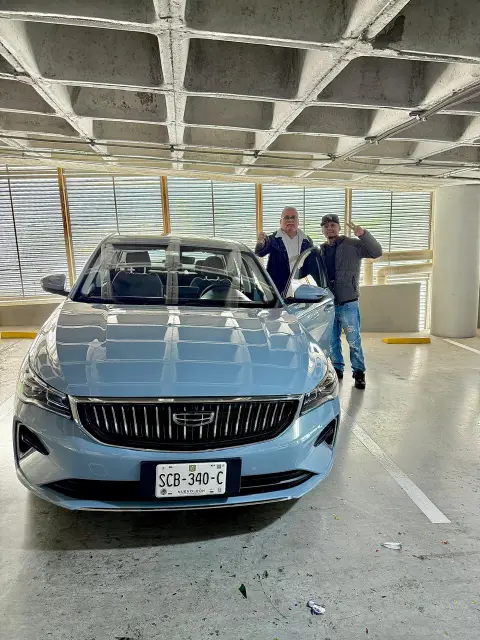 Cliente de Auto Crédito Valle recibiendo su Geely
